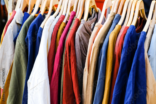 Wallpaper Mural Sale of clothing in the store. Lots of colorful T-shirts on the hanger. Torontodigital.ca