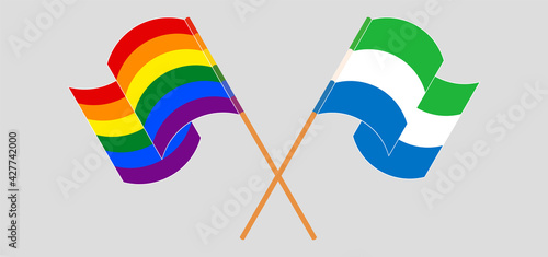Crossed and waving flags of LGBTQ and Sierra Leone