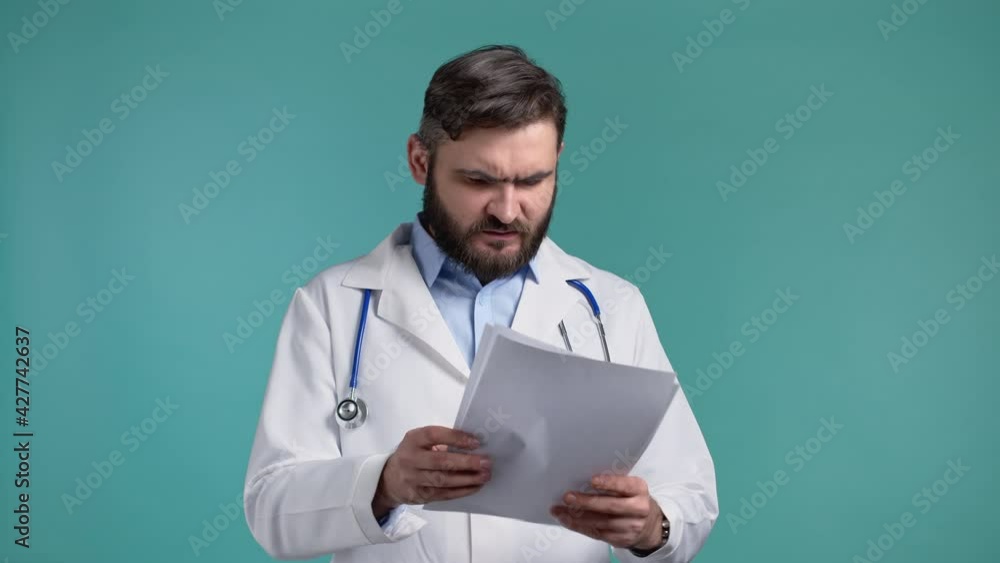 Angry doctor throws away papers. Furious male doc man throwing crumpled