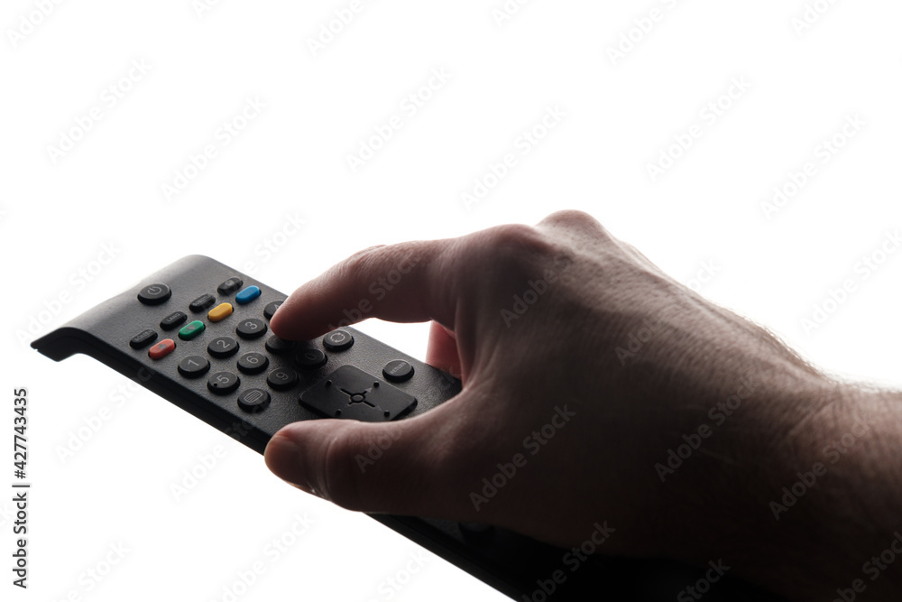 Hand holding tv remote isolated on white background. Hand holding tv remote isolated on white background.
