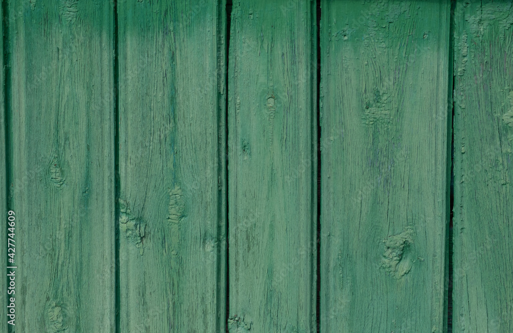 Old, cracked wood planks, painted a light green that had faded in the sun. Old, cracked wood planks, painted a light green that had faded in the sun.