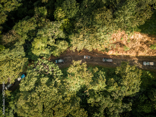Aerial view of car caravan in the middle of mountains