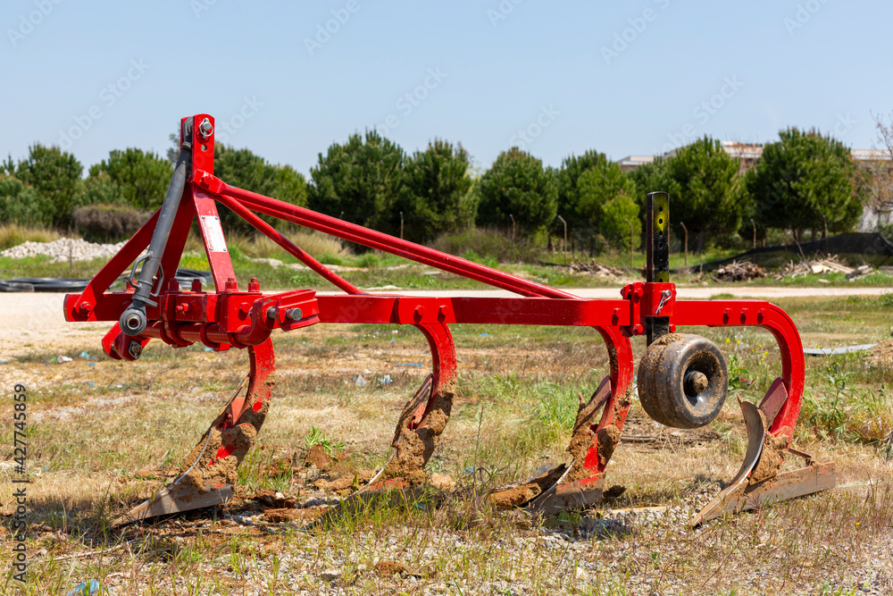 Red colored, 4-tooth plow