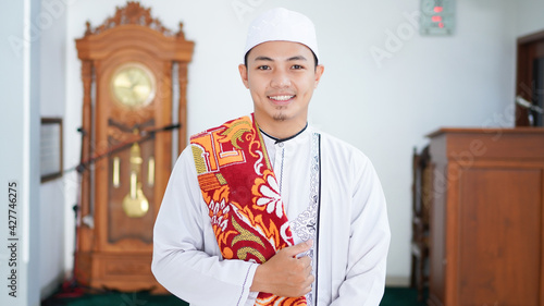 A portrait of an asian muslim man stylish at mosque, after sholat