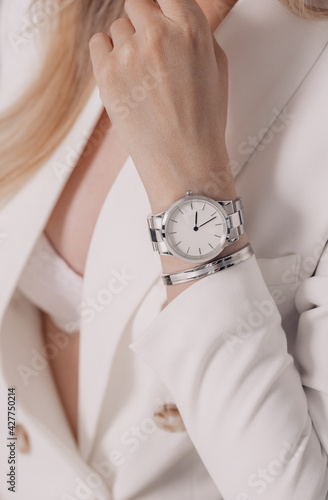 Stylish beautiful white watch on woman hand