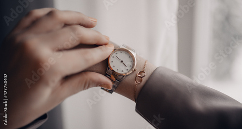 Stylish golden white classic watch on woman hand