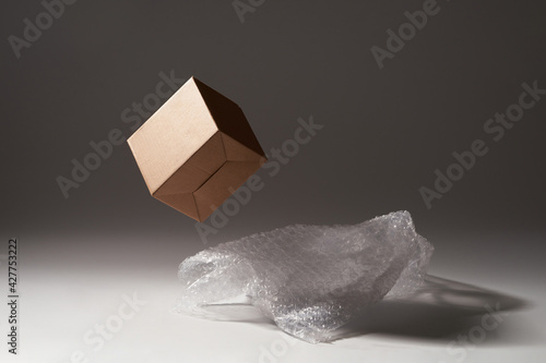 Close-up of cardboard box and bubble wrap on dark background