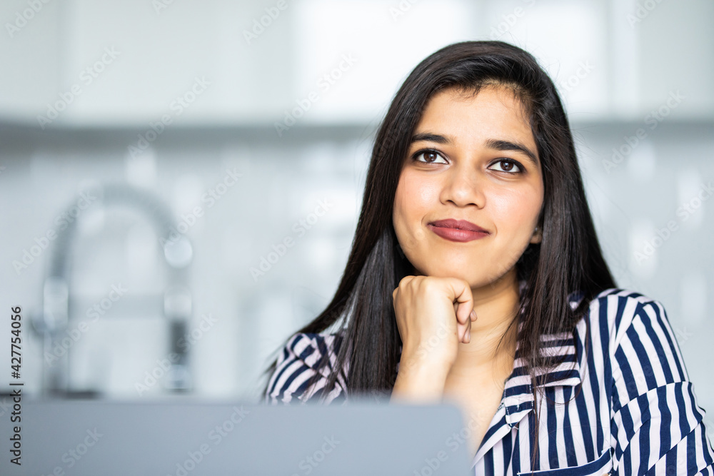 Indian beautiful young woman using laptop at home Indian beautiful young woman using laptop at home