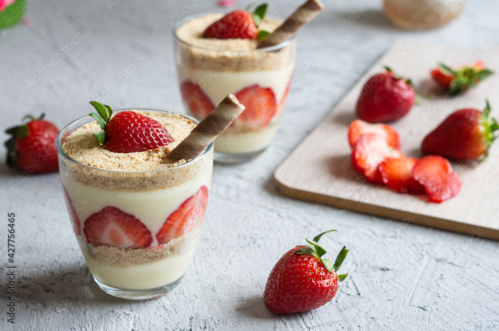 Magnolia dessert with fresh strawberries in glass cup, homemade milky dessert concept Magnolia dessert with fresh strawberries in glass cup, homemade milky dessert concept