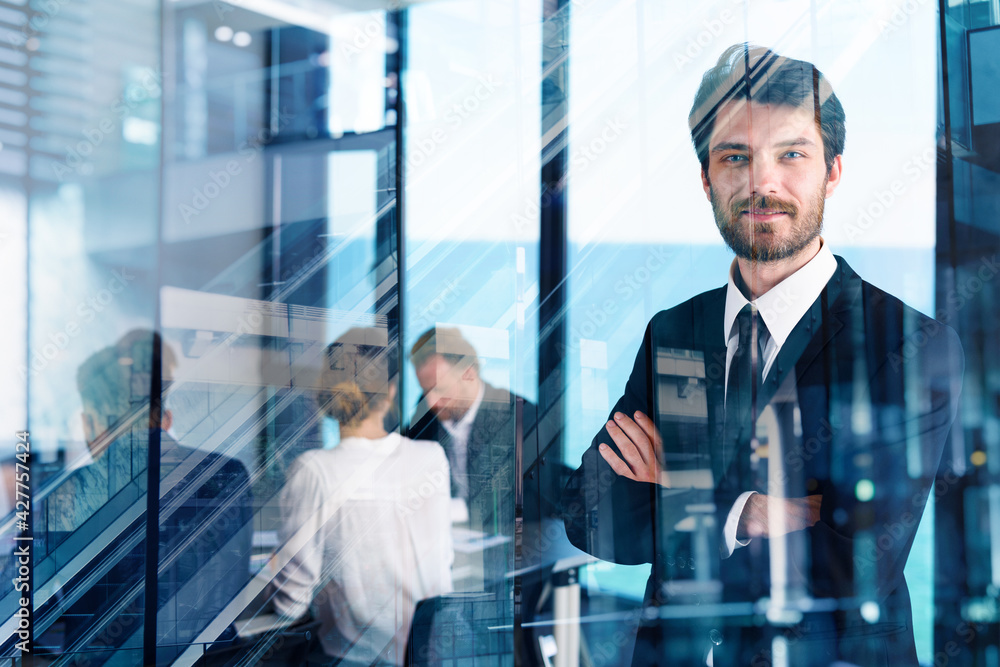 Confident businessman in office with his teamwork. Concept of cooperation Confident businessman in office with his teamwork. Concept of cooperation