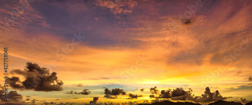 nature background of Summer orange and yellow sky with moving clouds. sun shining at sunset of Seychelles islands at sunset with copy space.