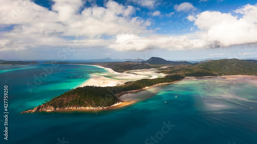 Aerial shot of Hill Inlet over Whitsunday Island - swirling white sands, sail boats and blue green water make spectacular patterns