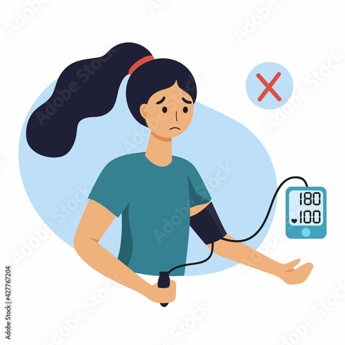 A woman with high blood pressure. The girl measures the pressure with a tonometer.