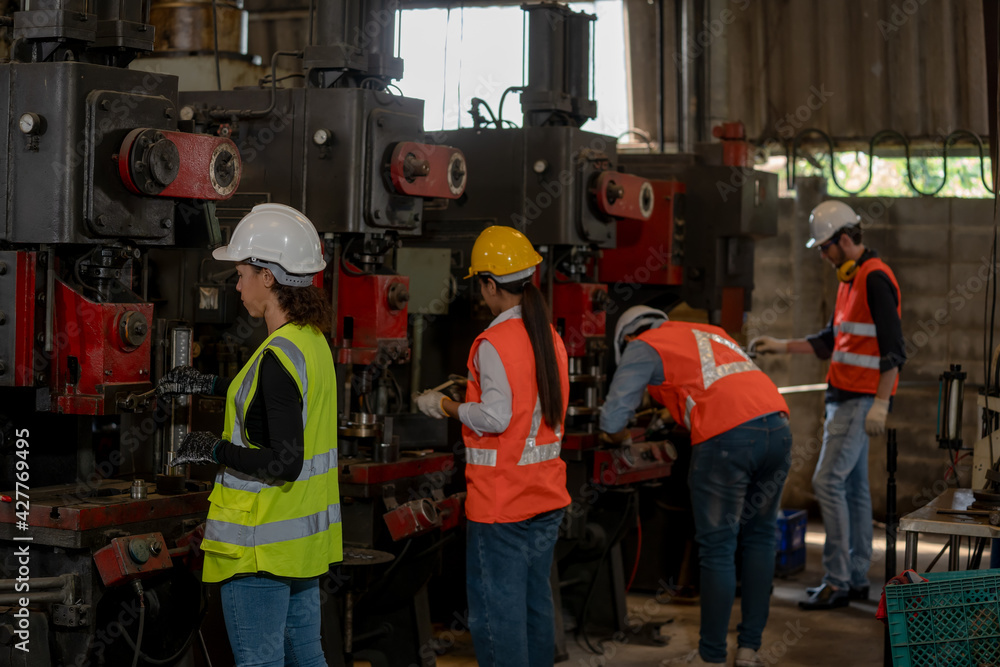 Group of technician working and inspecting metal component at lathes machine in industry factory. Group of technician working and inspecting metal component at lathes machine in industry factory.