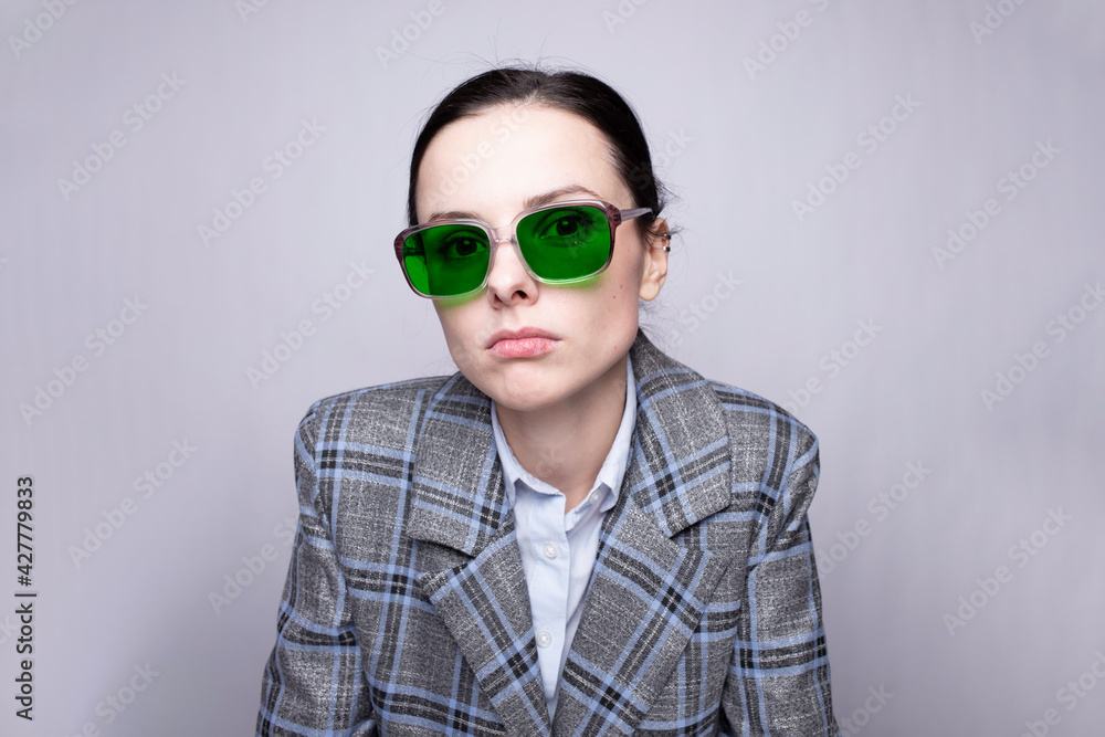 female boss in a cage suit and green glasses female boss in a cage suit and green glasses