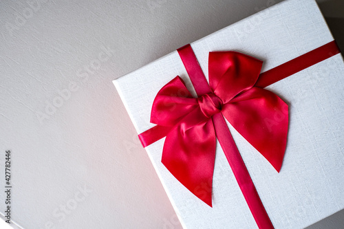 Valentine present. Gift box and red ribbon for romantic couple.Gift box and ribbon with tag for valentine present © Charlie's