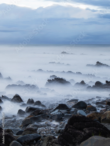 Layer of rocks on the beach coastline.