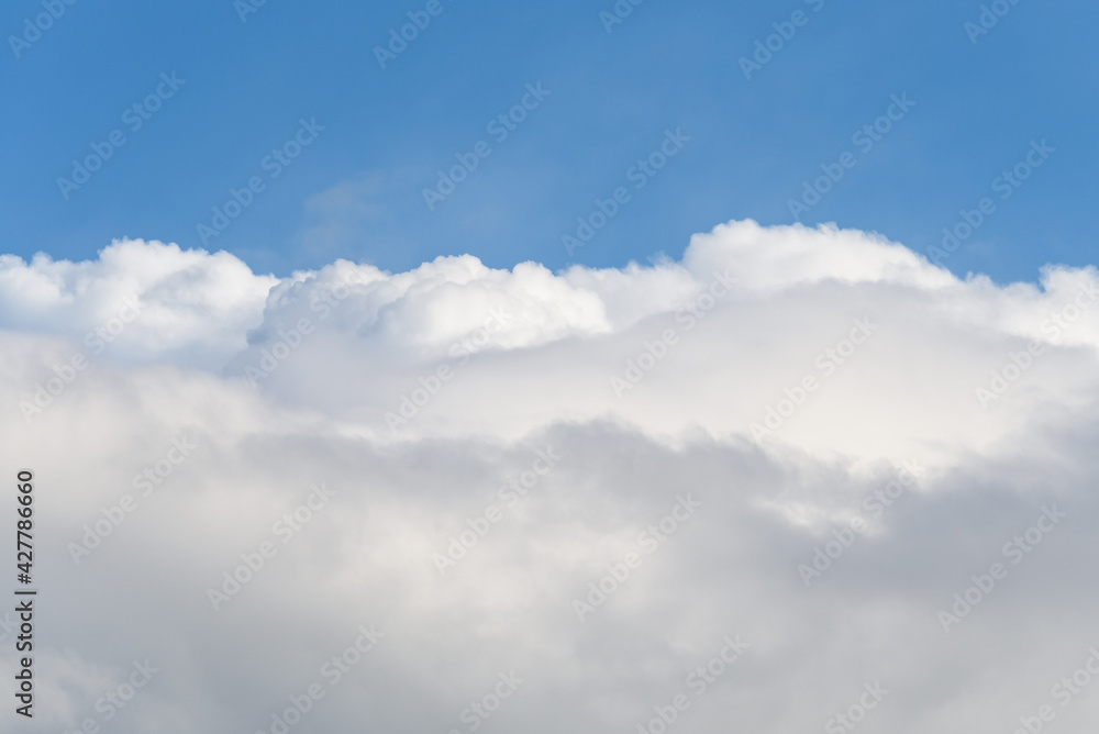 Blue sky with white clouds on a spring day as a nature background
