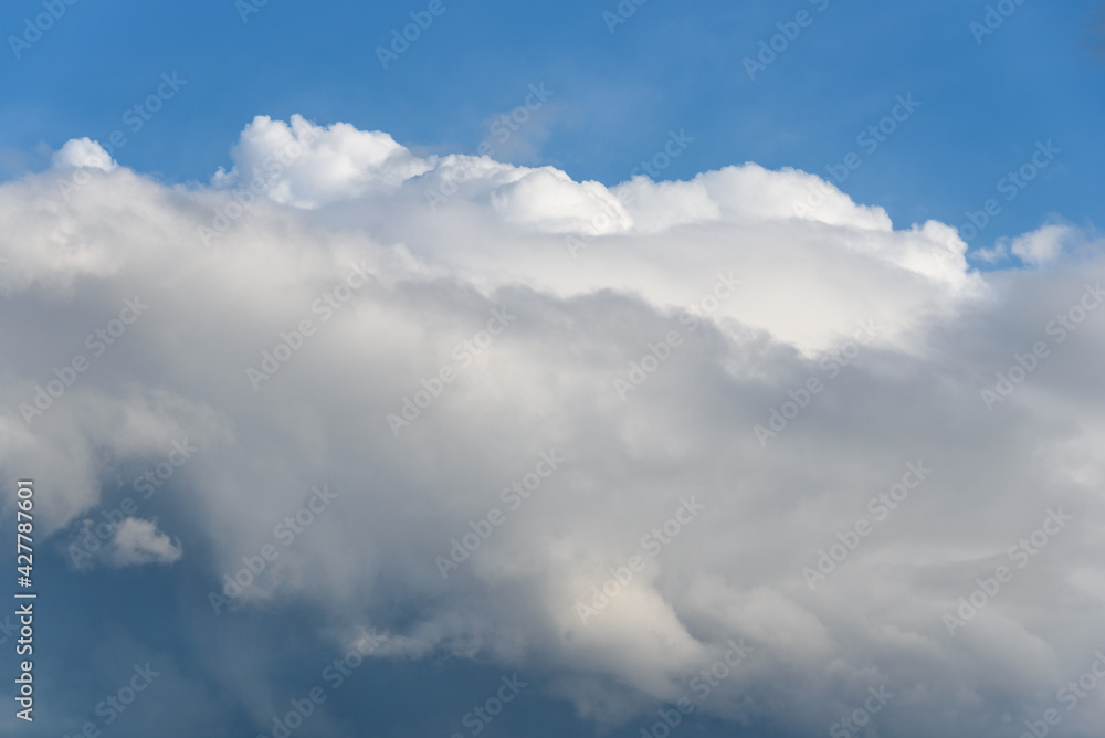 Blue sky with white clouds on a spring day as a nature background
