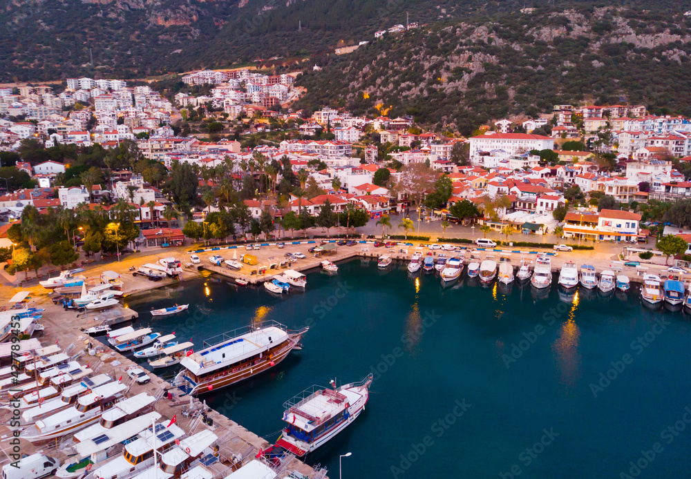 View from drone of small Turkish town of Kas on Turquoise Coast of Aegean Sea overlooking embankment and marina