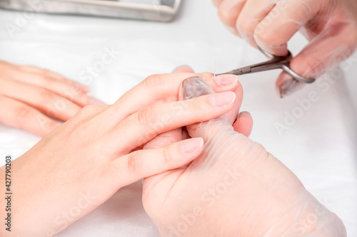Close-up of female hands during a manicure procedure in the salon.