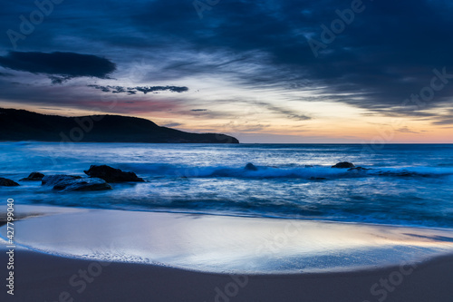 Sunrise at the beach with high cloud