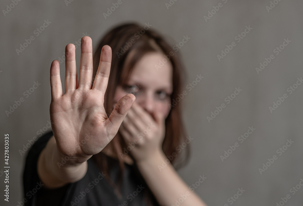 Crying teenage girl showing a stop sign with her hand Crying teenage girl showing a stop sign with her hand