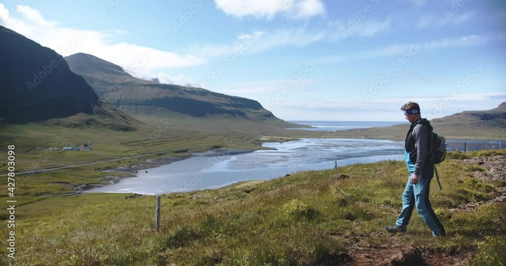 Walking caucasian man and beautiful Iceland landscape, slow motion view Walking caucasian man and beautiful Iceland landscape, slow motion view
