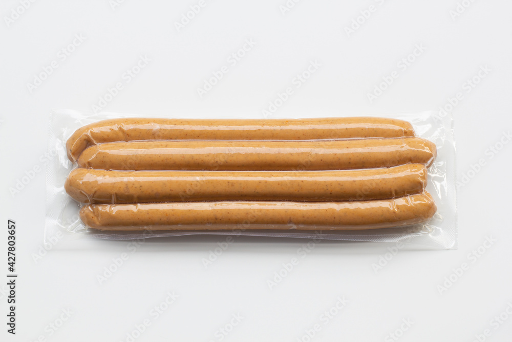 Top view of fresh uncured pork frankfurter sausages packaged in vacuum plastic pack isolated on a white background. Top view of fresh uncured pork frankfurter sausages packaged in vacuum plastic pack isolated on a white background.
