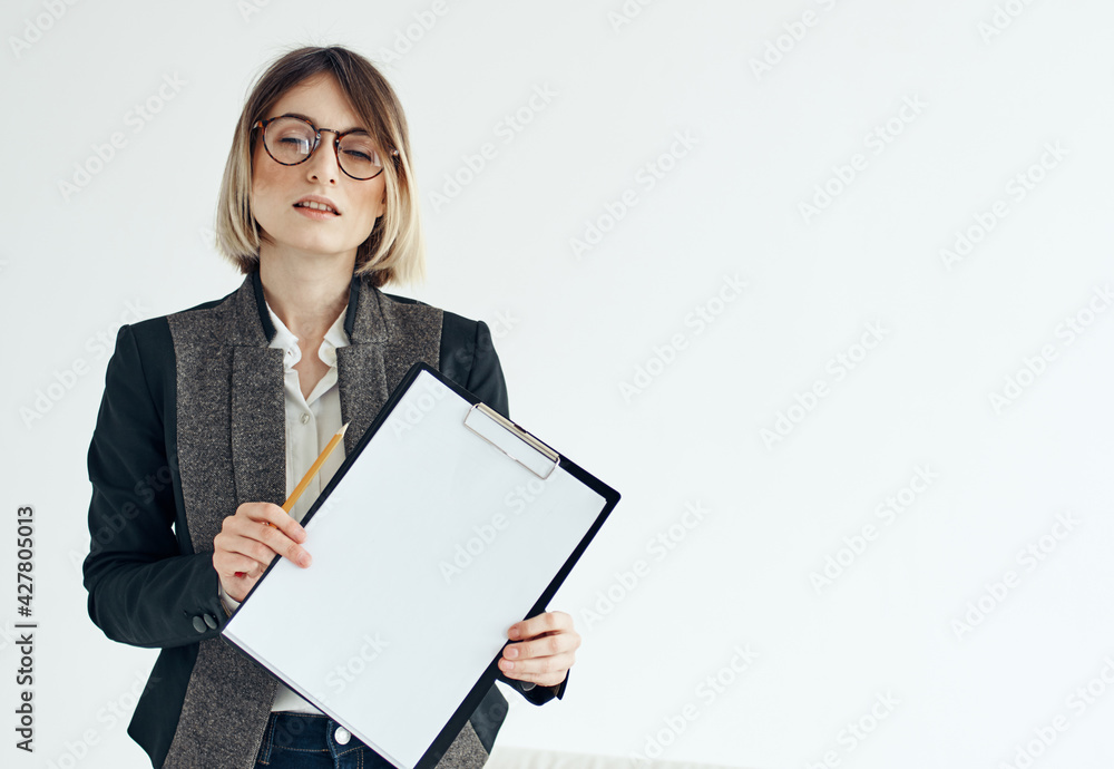 Business woman in a jacket manager model glasses and a white sheet of paper Business woman in a jacket manager model glasses and a white sheet of paper