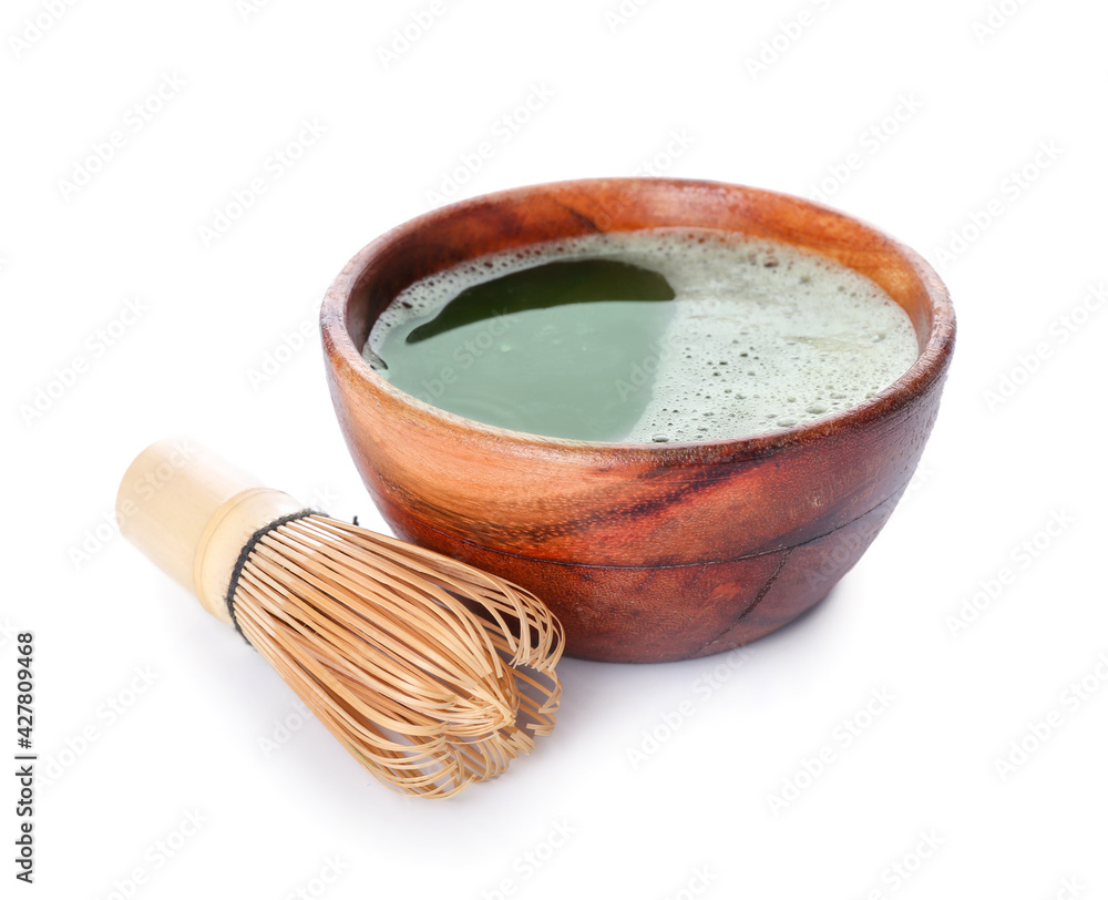 Bowl with matcha tea and chasen on white background Bowl with matcha tea and chasen on white background