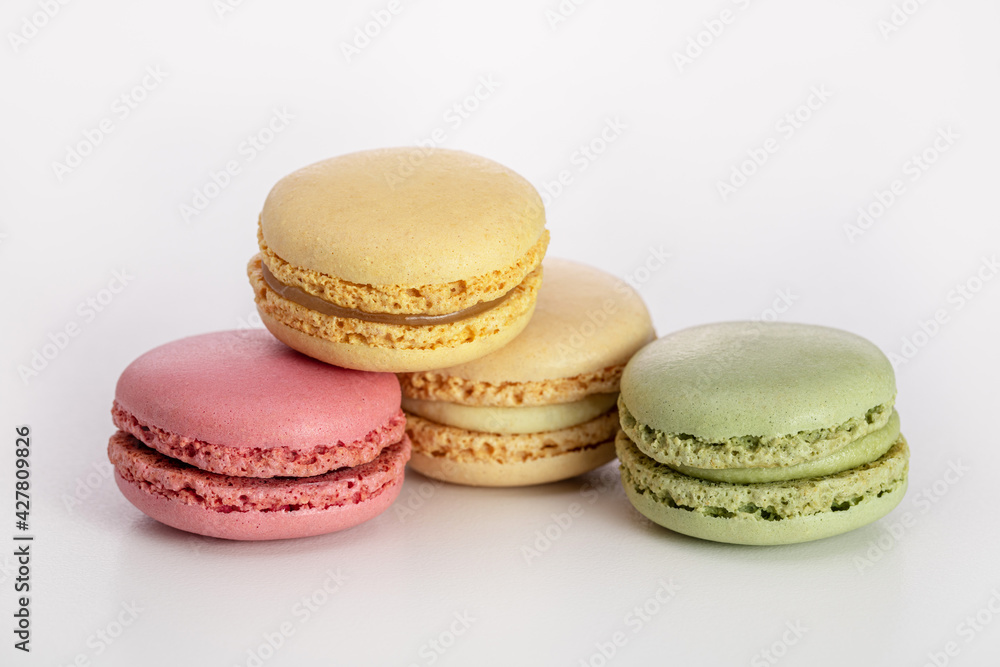 Macarons, multicolored cookies with filling on a light background. Close-up, copy space. Macarons, multicolored cookies with filling on a light background. Close-up, copy space.