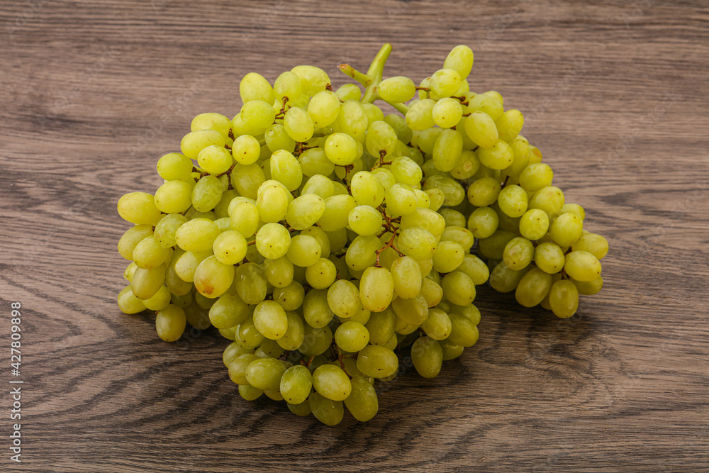 Green grape branch over background Green grape branch over background