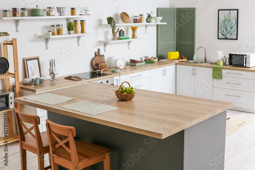 Bild auf Leinwand Dining table with apples in interior of modern kitchen