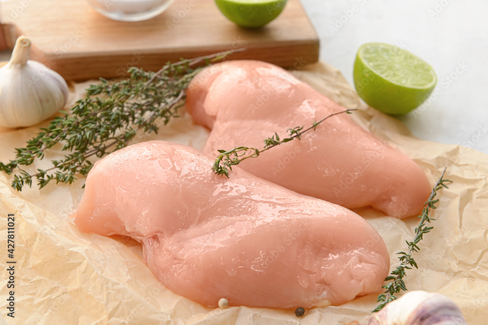 Raw chicken fillet on light background, closeup