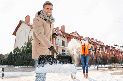 Family removing snow outdoo...