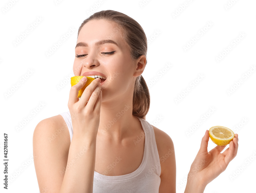 Beautiful young woman with cut lemon on white background Beautiful young woman with cut lemon on white background