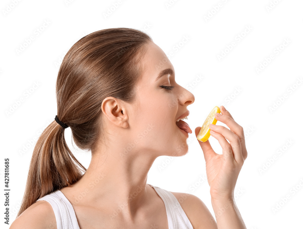 Beautiful young woman with cut lemon on white background Beautiful young woman with cut lemon on white background