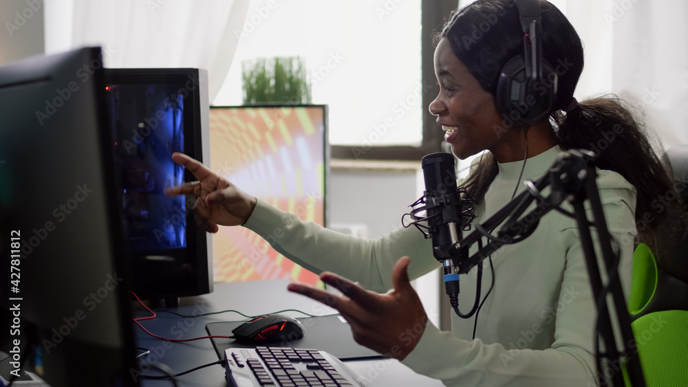 Streamer woman winning space shooter video game during esport tournament. Pro gamer using wireless controller, professional RGB mouse and headset late at night in streaming home Streamer woman winning space shooter video game during esport tournament. Pro gamer using wireless controller, professional RGB mouse and headset late at night in streaming home