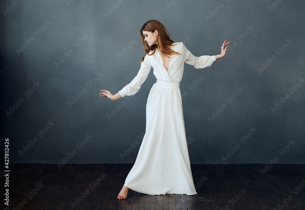 Romantic woman in full growth on a gray background in a white dress Copy Space Romantic woman in full growth on a gray background in a white dress Copy Space