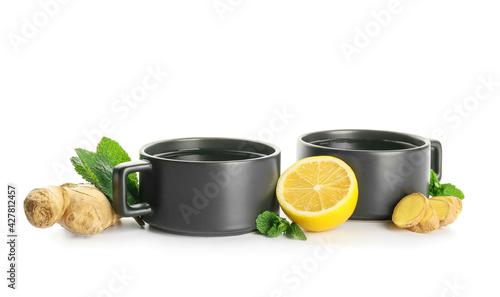 Cups of tea with ginger  mint and lemon on white background