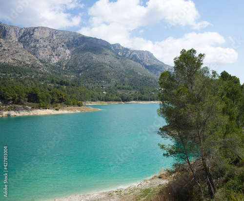 An idyllic lake between mountains.Guadalest reservoir in Alicante, Spain. © ruthlaguna
