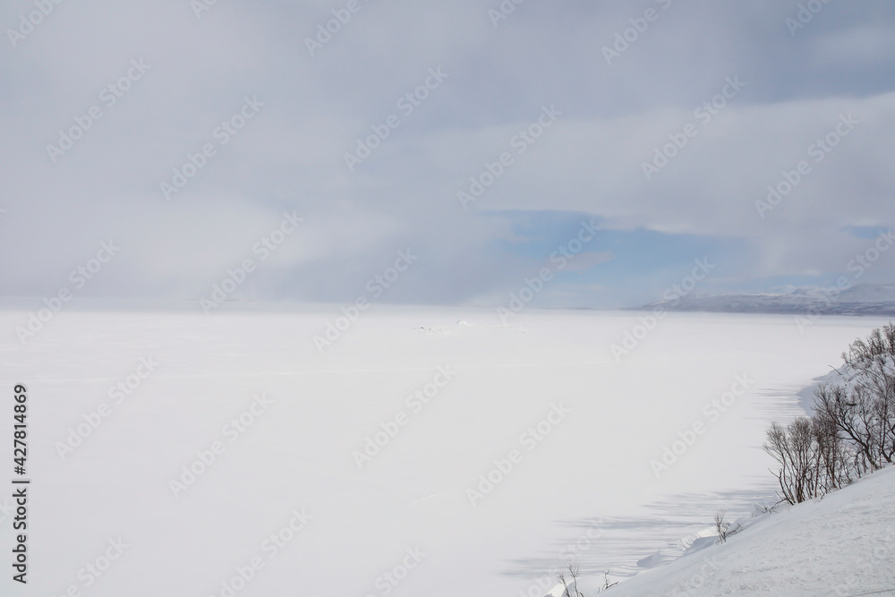 Tornestrask, Sweden A snowy and Arctic landscape over the Tornetrask lake in springtime.