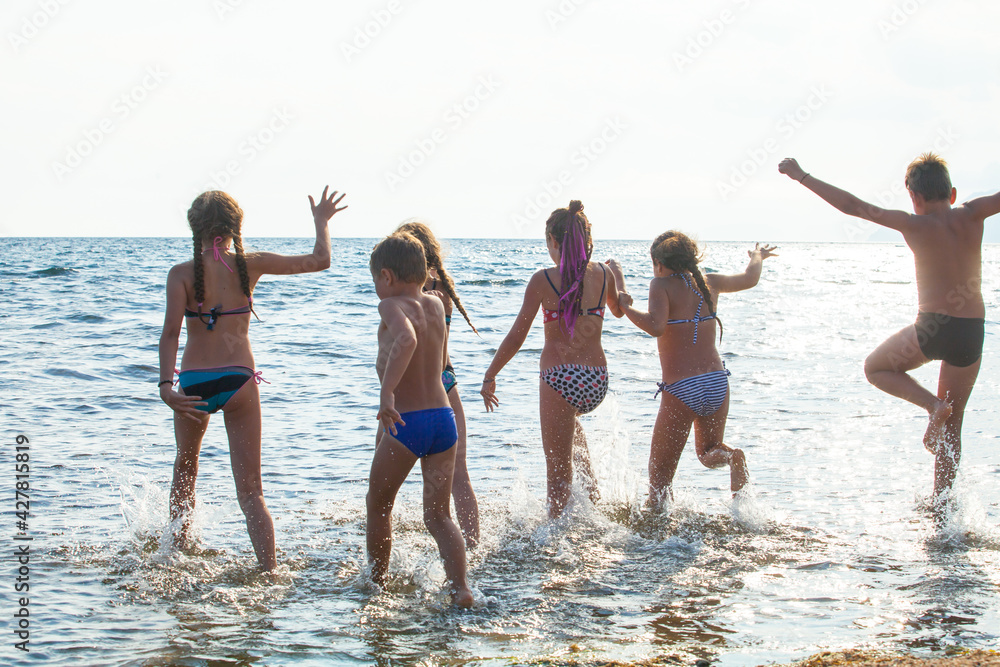 A group of young people dancing on the ocean