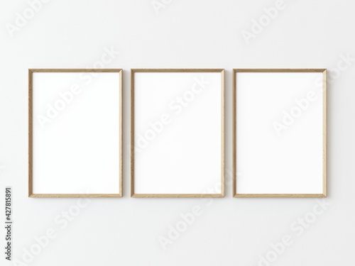 Three light wood rectangular vertical frames hanging on a white textured wall mockup, Flat lay, top view, 3D illustration