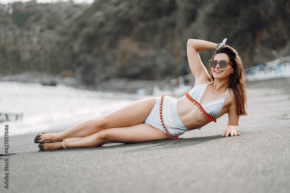 Girl in a stylish swimsuit have a rest n a beach Girl in a stylish swimsuit have a rest n a beach