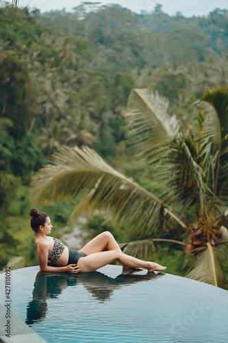 Woman in a swimming pool on a jungle view © prostooleh