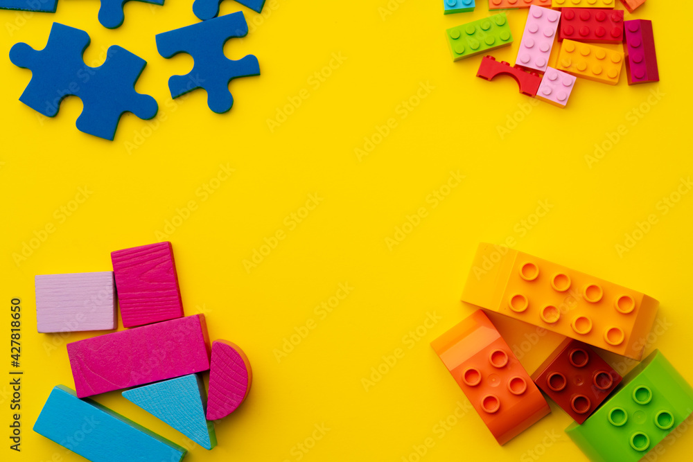 Obraz premium Toy kid's constructor on yellow background top view