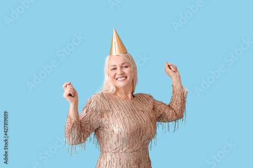 Happy mature woman in party...