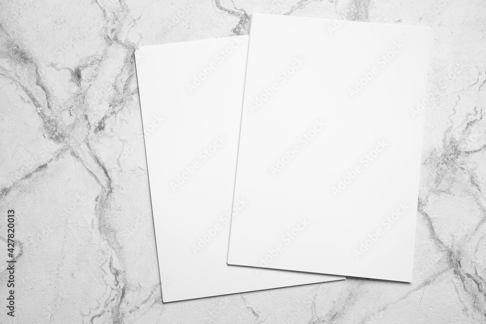 Blank sheets of paper on light background StockFoto Adobe Stock